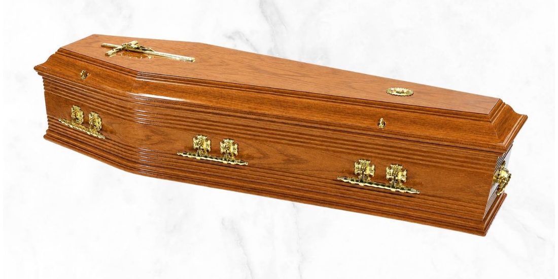 The Brosna veneer ribbed oak coffin with gloss finish and gold Oscar handles