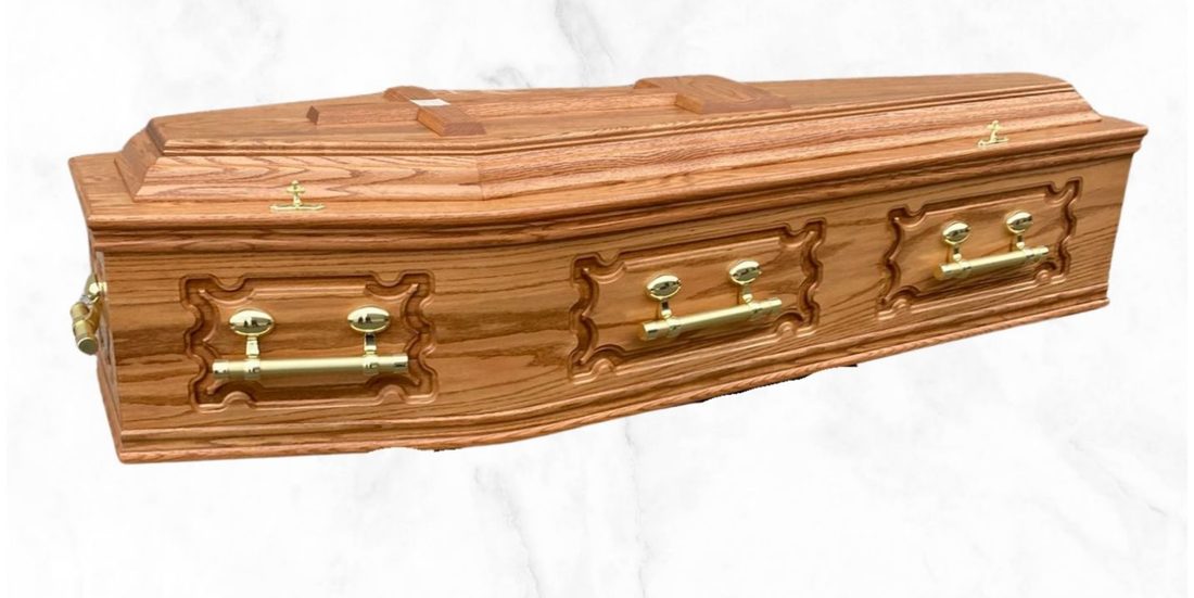 The Rustic veneer rustic oak coffin with gloss finish and gold Oscar handles