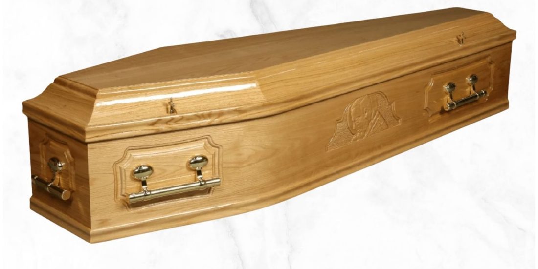 The Solid Image fully solid oak coffin with carved design finish and brass barrel handles