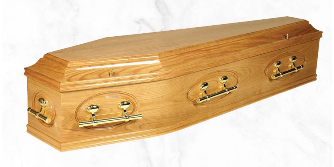 The Tara Oak full solid oak coffin with oval design, gloss finish and brass barrel handles