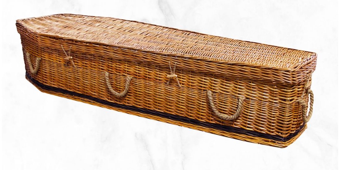 The Willow coffin, hand-woven with a calico interior and rope handles